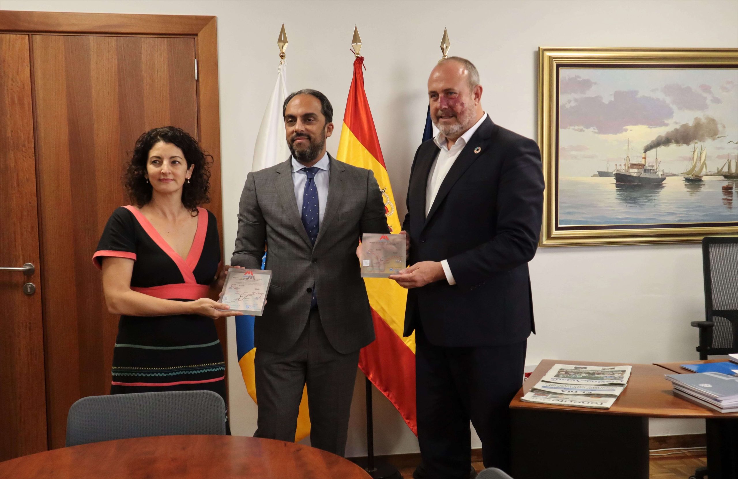El director de Cross Capital entrega la placa al presidente y a la directora financiera de Metrotenerife.